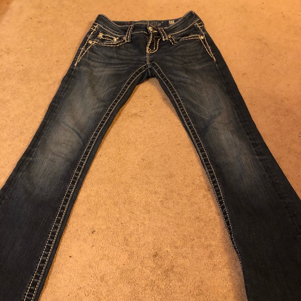 A pair of Miss Me jeans